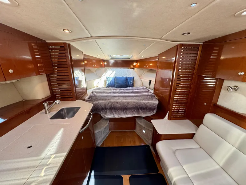 Slide: The Image of Luxurious interior of 2009 Sea Ray 350 Sundancer yacht with bed, sink, and seating area. - 20