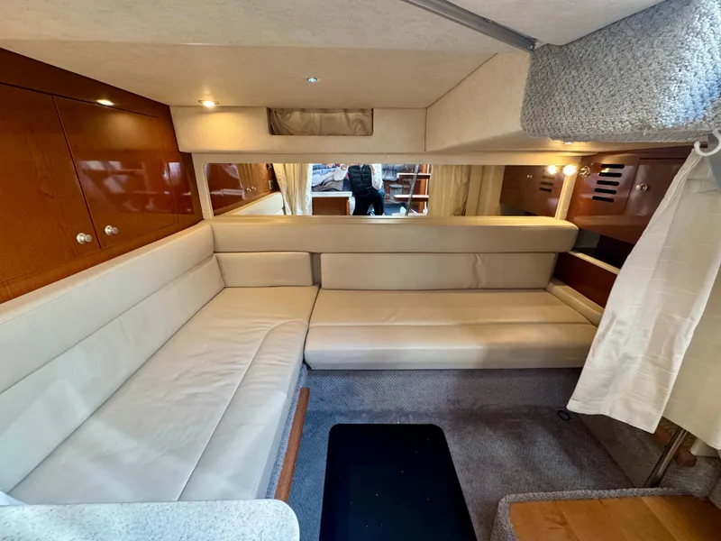 Slide: The Image of Interior of 2009 Sea Ray 350 Sundancer with beige seating and wooden accents. - 29