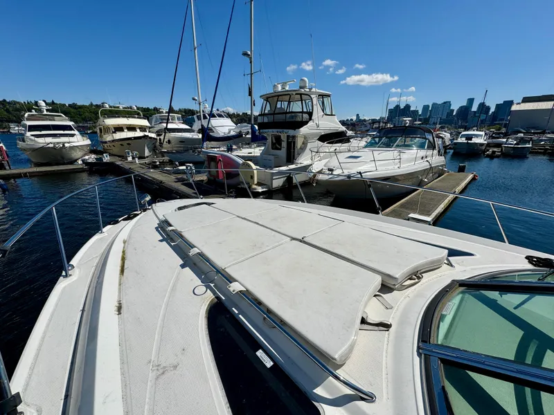 Slide: The Image of 2009 Sea Ray 350 Sundancer docked at marina with city skyline in background. - 7