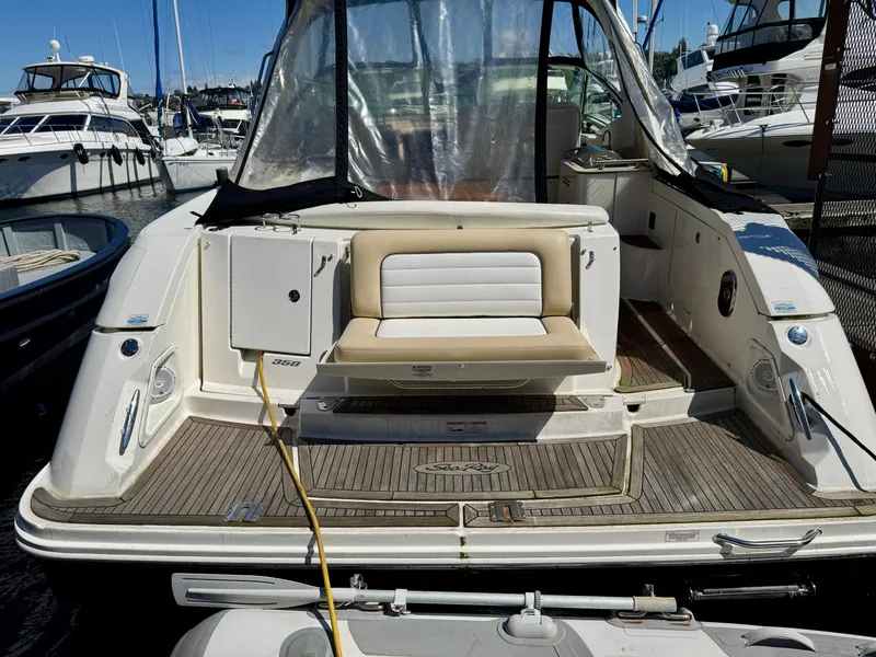 Slide: The Image of 2009 Sea Ray 350 Sundancer yacht docked at marina, rear view with seating area. - 9