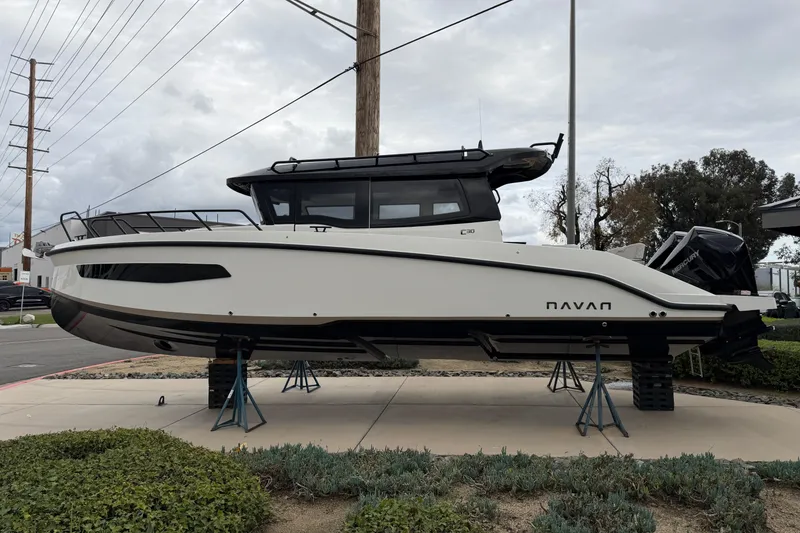 The Image of 2026 Navan C30 boat displayed on stands outdoors, side view. - 2