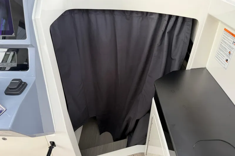 Slide: The Image of Interior view of 2026 Navan C30 boat cabin with curtain and control panel. - 26