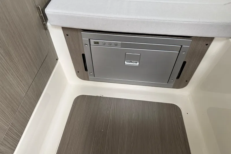 Slide: The Image of 2026 Navan C30 interior with built-in Vitrifrigo fridge and wood paneling. - 31