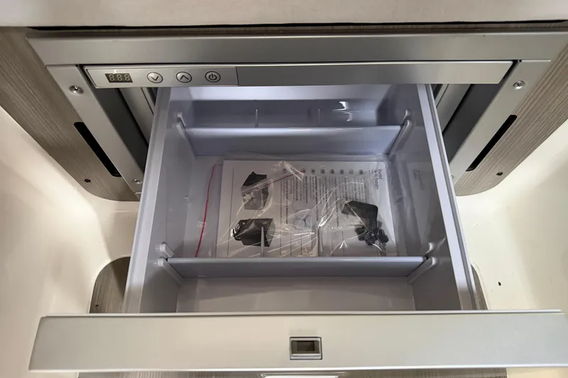 Slide: The Image of Open drawer of Navan C30 2026 with manual and accessories inside. - 32