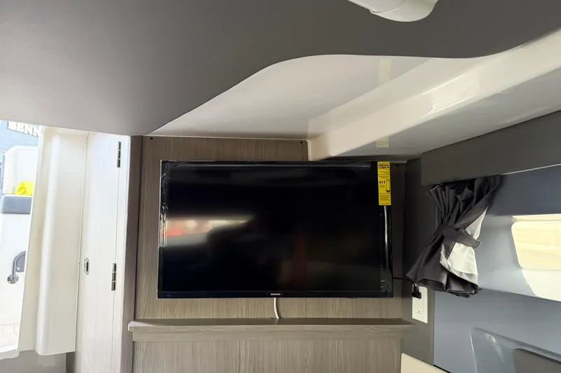 Slide: The Image of Interior of 2026 Navan C30 featuring a mounted flat-screen TV and modern design elements. - 34