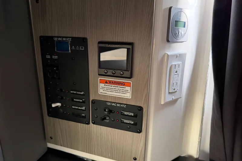 Slide: The Image of Control panel of 2026 Navan C30 with electrical outlets and warning label. - 35