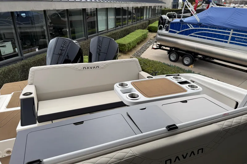 Slide: The Image of 2026 Navan C30 boat interior with seating, cup holders, and storage compartments. - 46