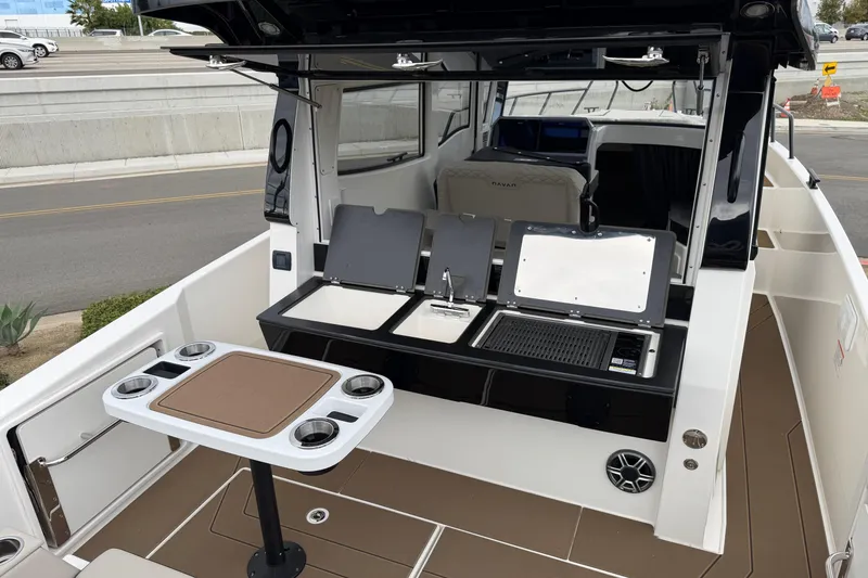 Slide: The Image of 2026 Navan C30 boat interior with kitchenette and seating area. - 7