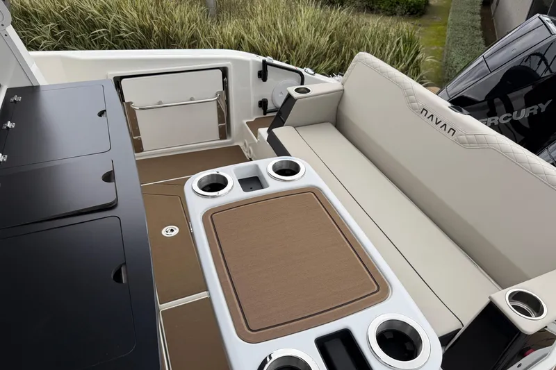 Slide: The Image of 2026 Navan C30 boat interior with seating, table, and cup holders. - 9