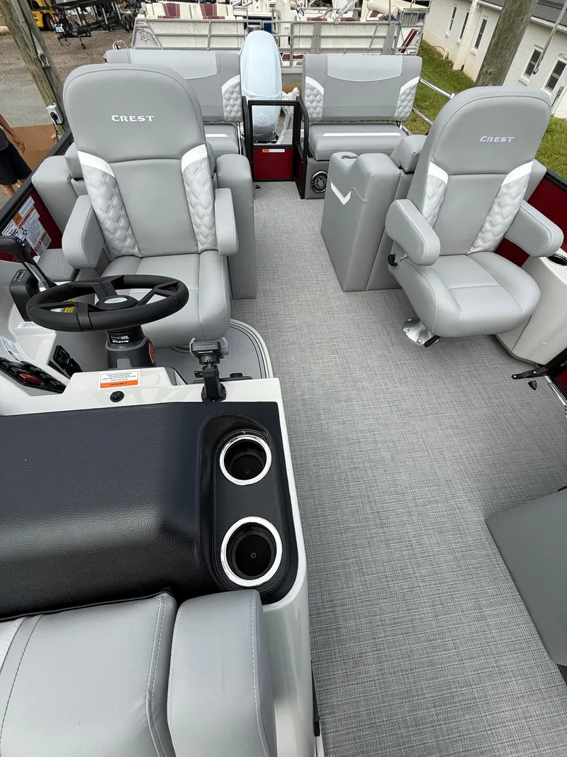 Slide: The Image of 2025 Crest 220 SLRC boat interior with gray seating and modern steering console. - 12