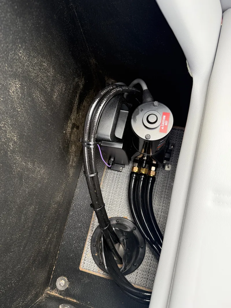 Slide: The Image of 2025 Crest 220 SLRC boat component with wiring and control unit in storage compartment. - 17