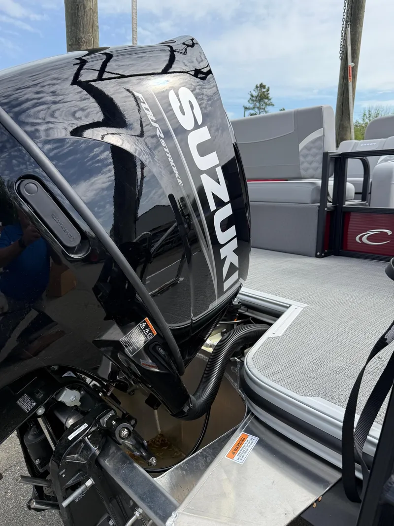 Slide: The Image of 2025 Crest 220 SLRC boat with Suzuki outboard motor, docked under a clear sky. - 27