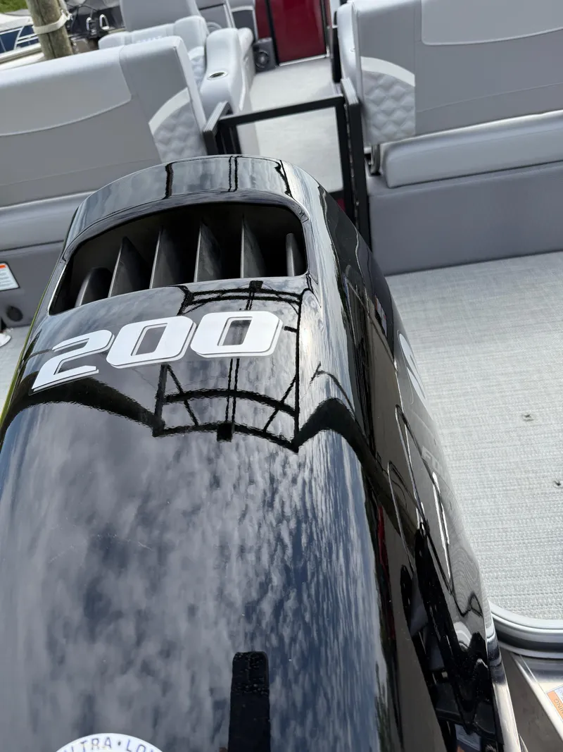 Slide: The Image of 2025 Crest 220 SLRC boat with powerful 200 HP engine, featuring sleek design and spacious seating. - 28