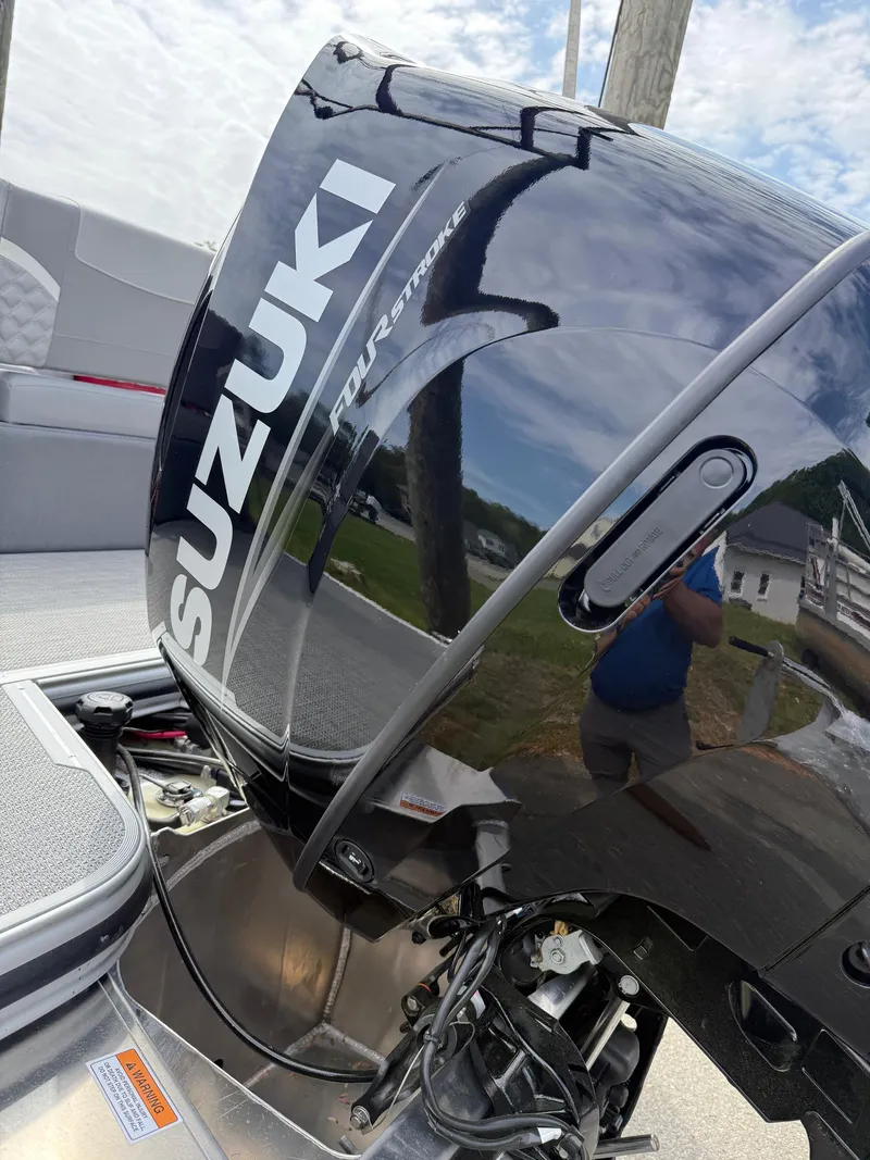 Slide: The Image of 2025 Crest 220 SLRC boat with Suzuki outboard motor, reflecting surroundings. - 29