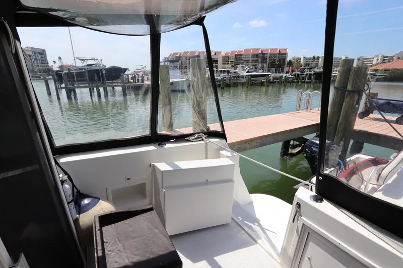 Slide: The Image of 2001 Navigator 4800 CLASSIC yacht interior with marina view, featuring seating and storage. - 11