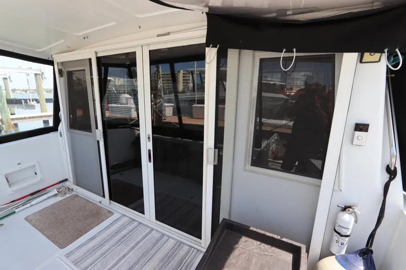 Slide: The Image of Interior view of 2001 Navigator 4800 CLASSIC yacht with sliding glass doors and striped rug. - 13