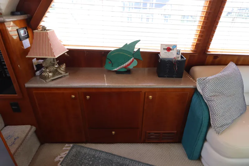 Slide: The Image of Interior of 2001 Navigator 4800 Classic yacht with wooden cabinetry and decorative items. - 18