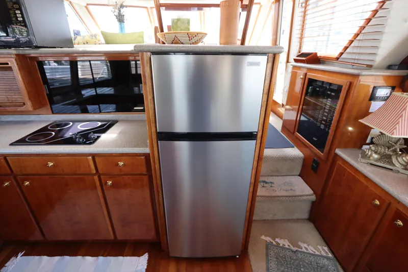 Slide: The Image of Modern kitchen interior on 2001 Navigator 4800 CLASSIC yacht with stainless steel appliances. - 27