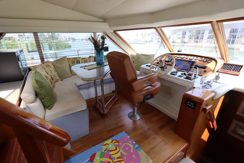Slide: The Image of Luxurious interior of 2001 Navigator 4800 CLASSIC yacht with helm, seating, and panoramic windows. - 28