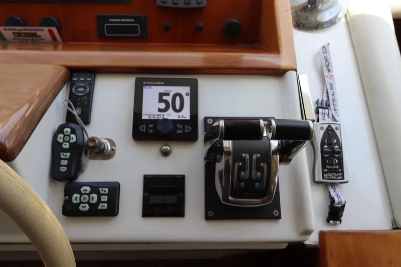 Slide: The Image of Control panel of a 2001 Navigator 4800 CLASSIC yacht with various instruments and controls. - 32