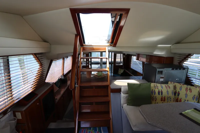 Slide: The Image of Interior of 2001 Navigator 4800 CLASSIC yacht with wooden stairs and cozy seating area. - 41