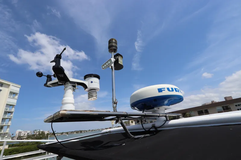 Slide: The Image of Weather instruments and radar on Navigator 4800 CLASSIC yacht, 2001 model, under a clear blue sky. - 45