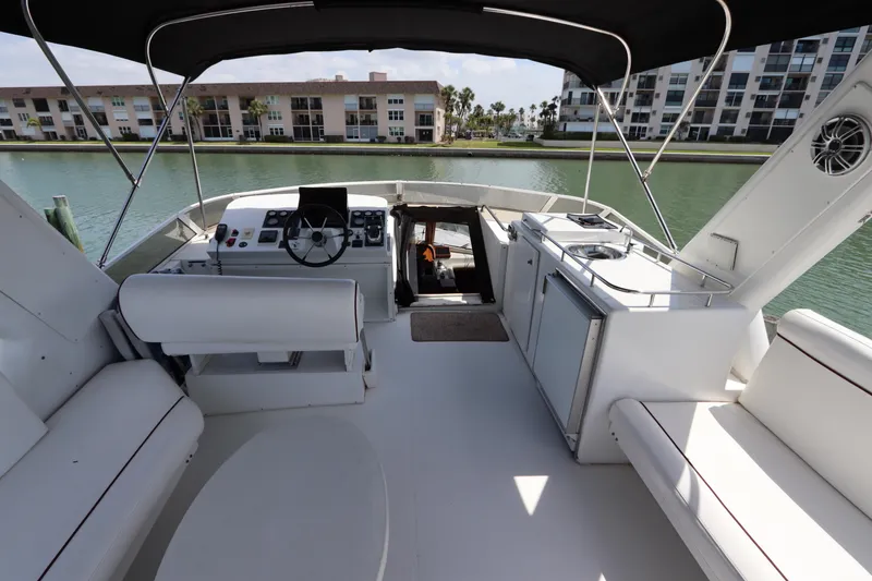 Slide: The Image of 2001 Navigator 4800 CLASSIC yacht interior with helm, seating, and waterfront view. - 48