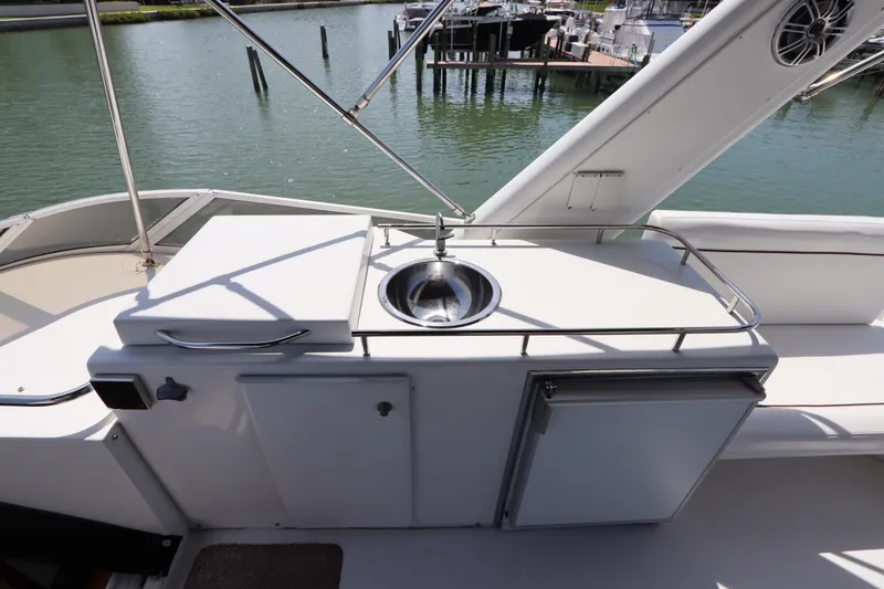 Slide: The Image of Outdoor sink and storage area on 2001 Navigator 4800 CLASSIC yacht deck. - 49