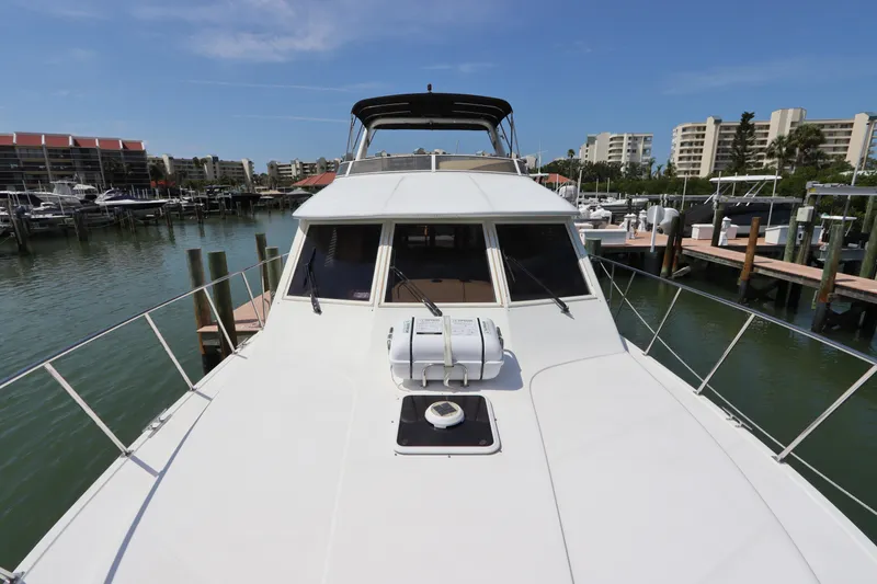 Slide: The Image of 2001 Navigator 4800 CLASSIC yacht docked in a marina with clear blue skies. - 6