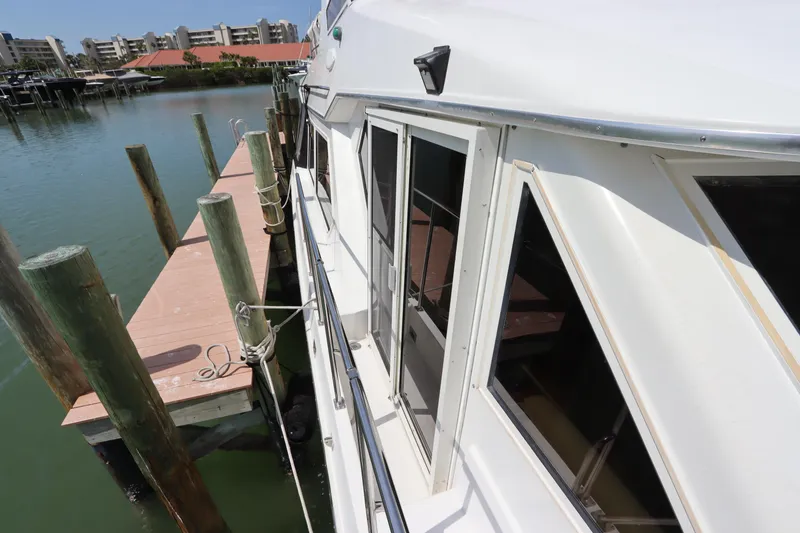 Slide: The Image of 2001 Navigator 4800 CLASSIC yacht docked at marina with waterfront view. - 7