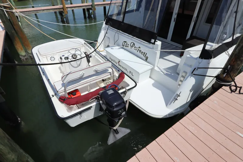 Slide: The Image of 2001 Navigator 4800 CLASSIC yacht docked with attached motorboat in a marina. - 8