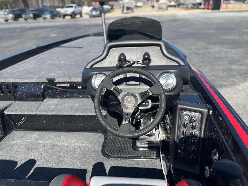 Slide: The Image of Cockpit of 2025 Phoenix 721 ZXL boat with steering wheel and control panel. - 10