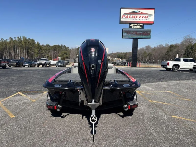 Slide: The Image of 2025 Phoenix 721 ZXL boat in parking lot, rear view, Palmetto Marine Center sign visible. - 3