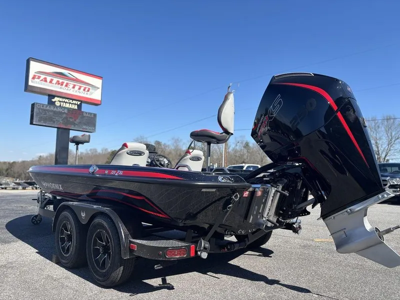 Slide: The Image of 2025 Phoenix 721 ZXL boat with powerful engine, parked outdoors under clear blue sky. - 5