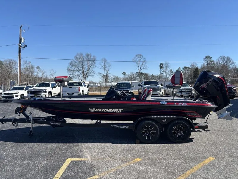 Slide: The Image of 2025 Phoenix 721 ZXL boat on trailer, parked outdoors, clear sky background. - 6