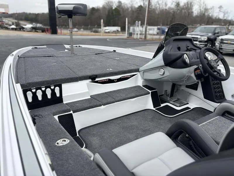 Slide: The Image of 2025 Phoenix 721 ZXL boat interior with modern dashboard and seating. - 12