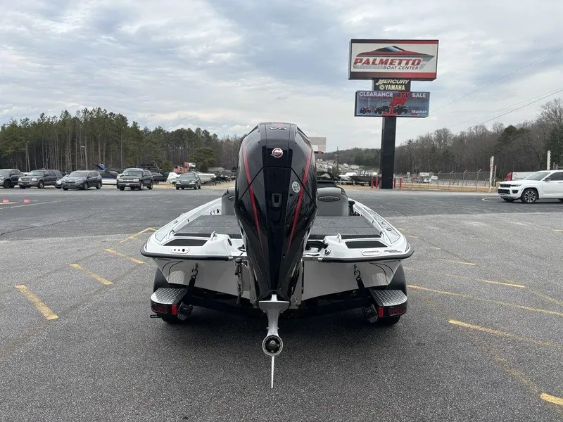 Slide: The Image of 2025 Phoenix 721 ZXL boat in parking lot, rear view, overcast sky. - 3