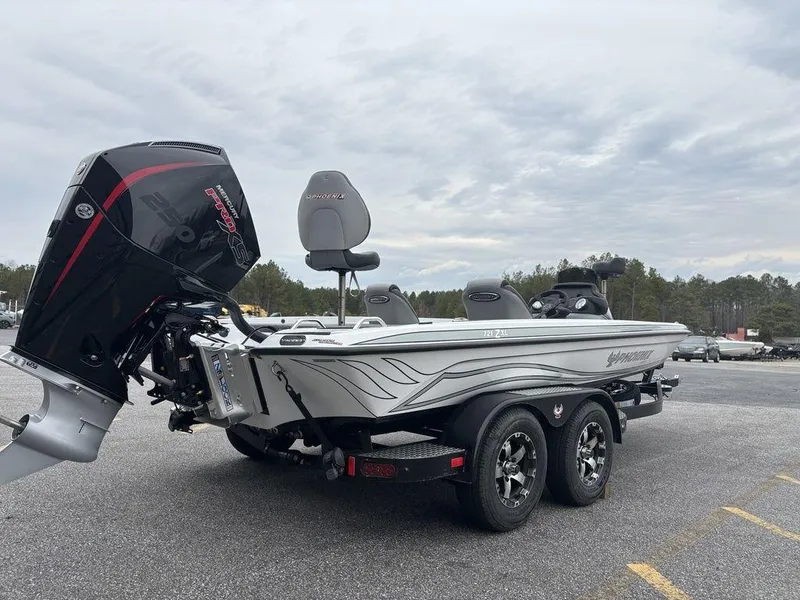 Slide: The Image of 2025 Phoenix 721 ZXL boat on trailer, parked outdoors, showcasing sleek design and powerful engine. - 4