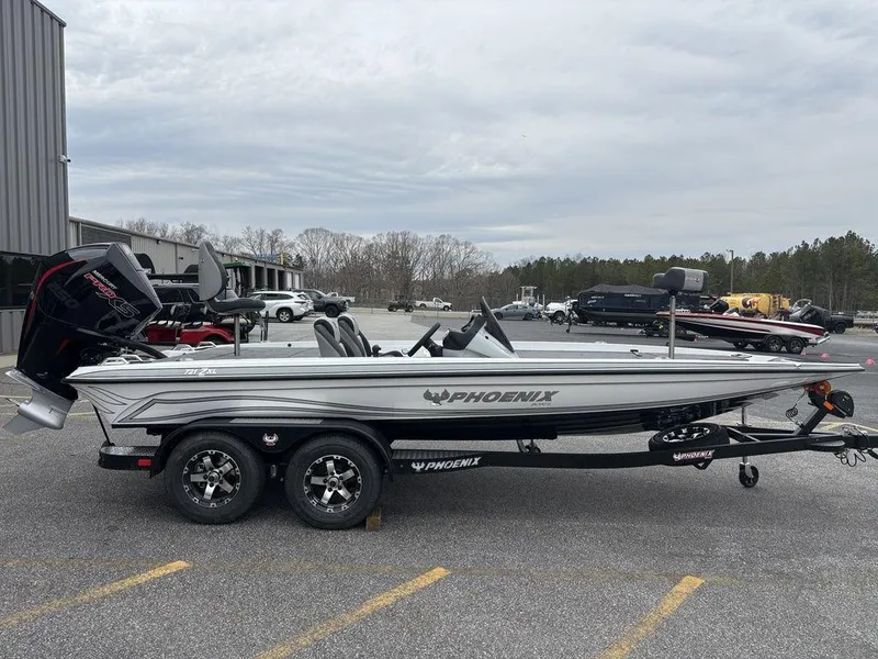 Slide: The Image of 2025 Phoenix 721 ZXL boat in a parking lot, side view, with trailer attached. - 5