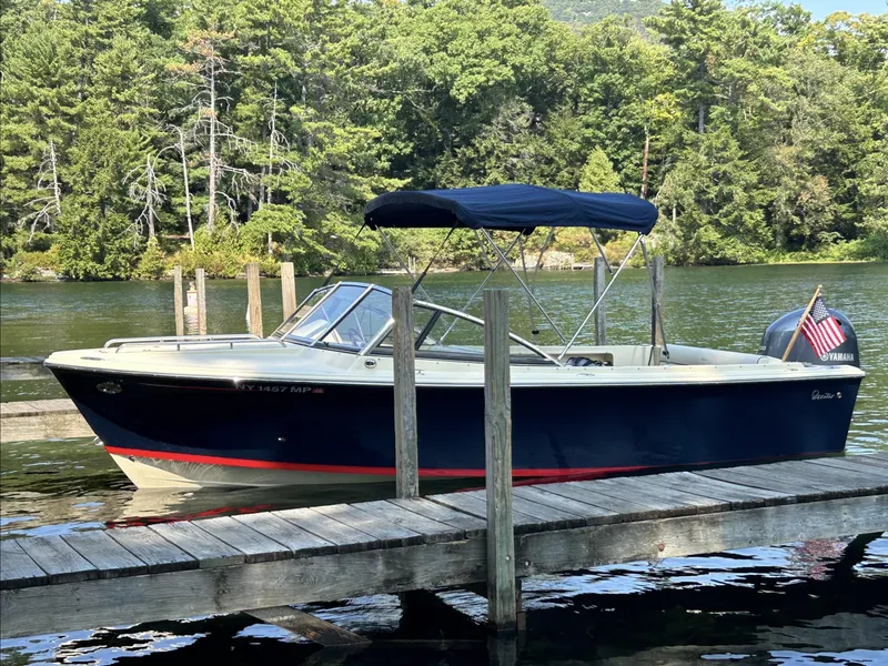 Slide: The Image of 2017 Rossiter 20 Coastal Cruiser docked on a serene lake with lush forest backdrop. - 0