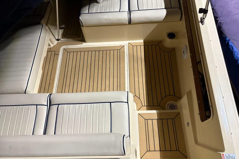 Slide: The Image of 2017 Rossiter 20 Coastal Cruiser interior with cushioned seating and wood-patterned flooring. - 13