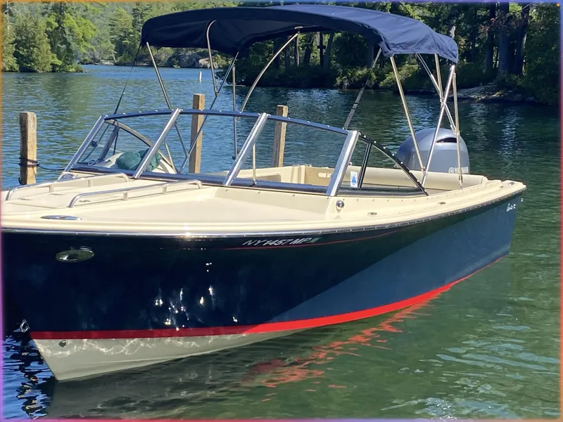 Slide: The Image of 2017 Rossiter 20 Coastal Cruiser boat with canopy on a serene lake. - 3