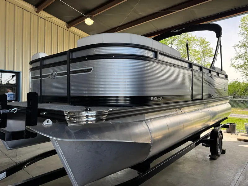 Slide: The Image of 2023 Qwest RLS 820 pontoon boat in a garage, showcasing sleek design and modern features. - 0