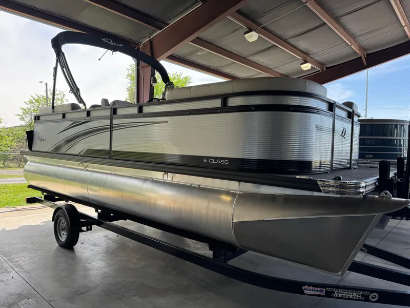 Slide: The Image of 2023 Qwest RLS 820 pontoon boat on trailer in covered storage area. - 1