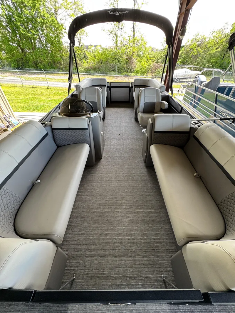 Slide: The Image of 2023 Qwest RLS 820 pontoon boat interior with spacious seating and canopy. - 2