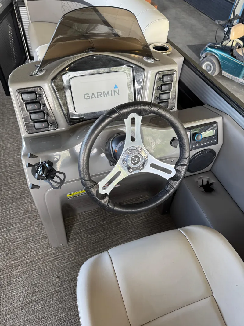 Slide: The Image of 2023 Qwest RLS 820 boat dashboard with Garmin navigation system and steering wheel. - 3