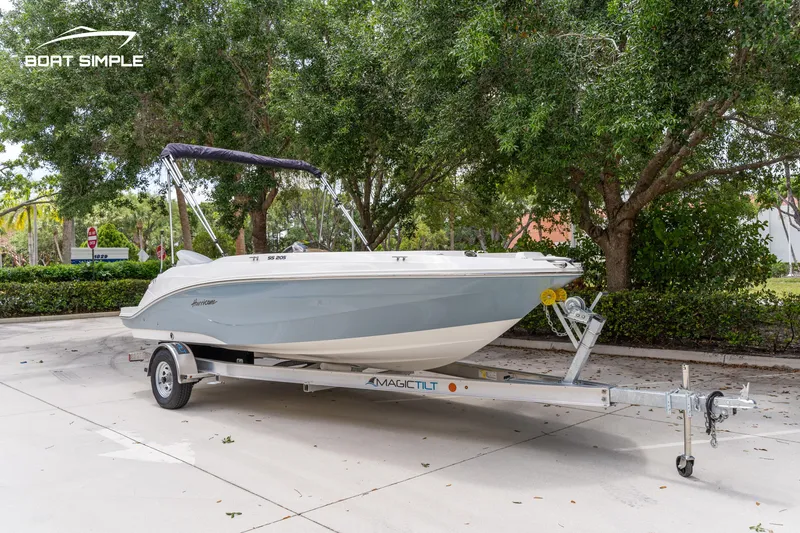 Slide: The Image of 2021 Hurricane SS 205 boat on trailer, parked outdoors with trees in the background. - 1