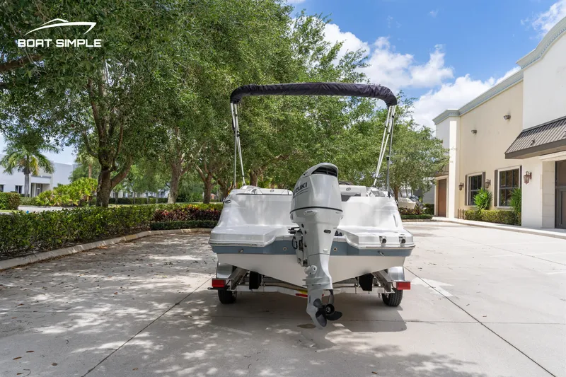 Slide: The Image of 2021 Hurricane SS 205 boat parked outdoors, rear view with outboard motor, sunny day. - 6