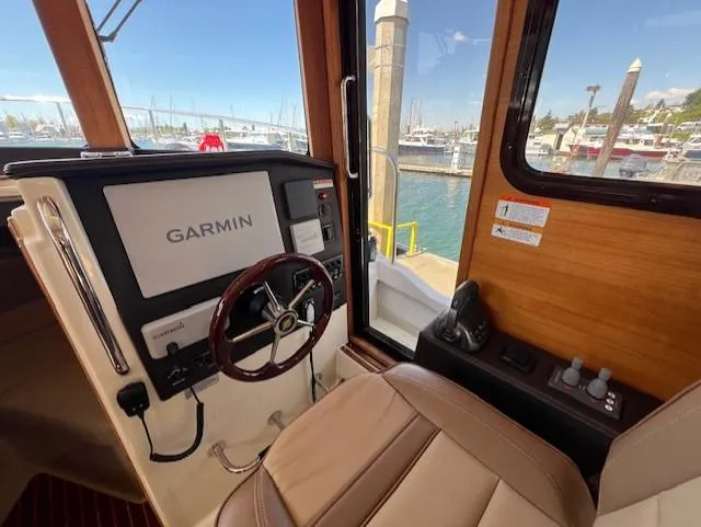 Slide: The Image of 2020 Ranger Tugs R-31 CB helm with Garmin navigation, docked at marina. - 14