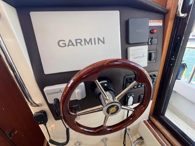 Slide: The Image of 2020 Ranger Tugs R-31 CB helm with Garmin navigation system and wooden steering wheel. - 15